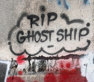 Graffiti is seen on a building next to the former Ghost Ship warehouse site on 31st Avenue near International Boulevard in Oakland, Calif., on Wednesday, May 24, 2023. A deadly fire killed 36 people there on Dec. 2, 2016.