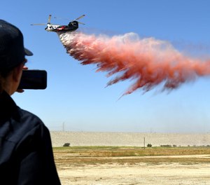 L.A. County firefighters watch as a fleet of firefighting helitankers, known as Quick Reaction Force (QRF), give a demonstration.