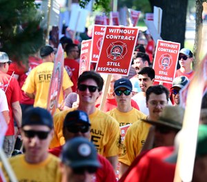 Off-duty St. Paul firefighters and paramedics are joined by supporters as they walk an informational picket.