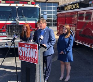 Dale Strong, surrounded by his family, outside the Monrovia Volunteer Fire Department in 2021.