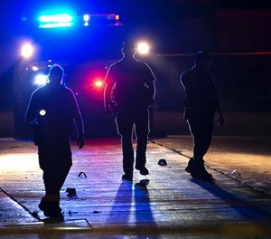 Police searched for evidence late Friday near N. Colfax Avenue and Webber Parkway, where a Minneapolis police officer was shot earlier in the night.