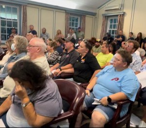 Residents and first responders in a packed committee meeting room at Upper Deerfield Township's Municipal Building awaiting committee members final vote on an ordinance to close Fire Station 32.