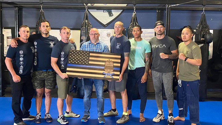Noel Greany delivers a memorial flag to Seattle Police Department's training annex to remember Officer Alexandra "Lexi" Harris. On June 13, 2021, Officer Harris was on her way home from work when she stopped to assist with a motor vehicle accident. Officer Harris was killed when she was accidentally struck by a motorist.