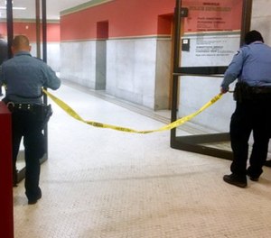 Police set up crime scene tape outside a Minneapolis police room at Minneapolis City Hall on Monday, Dec. 18, 2017.