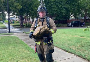 Firefighter Aaron Dickson posed for a photo with the large tortoise.