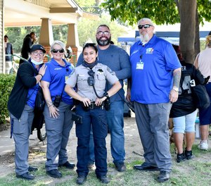 A Modesto Police officer stands with community outreach specialists, including representatives of HEART (Homeless Engagement and Response Team).