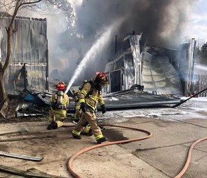 A Central firefighter became trapped when an overhang roof collapsed while crews were working a house fire Monday afternoon. (Photo/Central Fire Dept.)