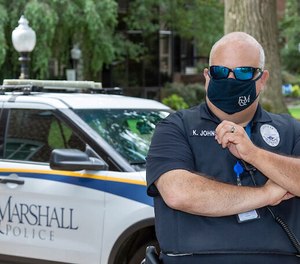 A Franklin & Marshall College police officer poses in front of a squad car in Lancaster, Pennsylvania.