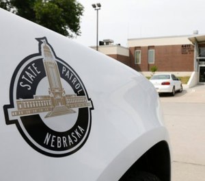 A vehicle with the Nebraska State Patrol logo is parked in a state patrol facility in Omaha, Neb., Wednesday, Aug. 2, 2017. A federal lawsuit accuses the Nebraska State Patrol that it has for years forced female recruits to submit to invasive, medically unnecessary pelvic exams performed by a male doctor before they can be hired. (AP Photo/Nati Harnik)