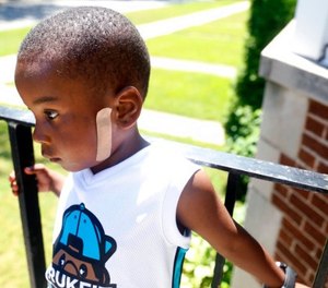 In this July 19, 2016 file photo, Kavan Collins, stands on his father's porch in Chicago. (AP Photo/Tae-Gyun Kim File)