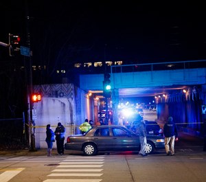 Police investigate the scene where two officers were killed after they were struck by a South Shore train near 103rd Street and Dauphin Avenue on Monday, Dec. 17, 2018, in Chicago. (Armando L. Sanchez/Chicago Tribune via AP)