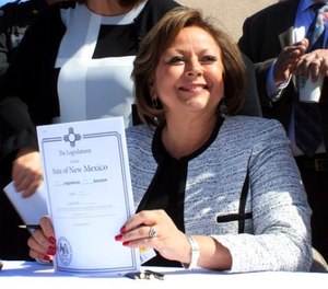 New Mexico Gov. Susana Martinez holds signed legislation that expands access to the overdose antidote naloxone during a ceremony at a substance abuse treatment center for youth in Albuquerque, N.M., on Thursday, April 6, 2017.