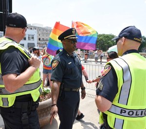 Police officers work security at a Pride Parade in Aurora, Illinois on June 19, 2018.