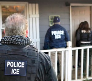 In this Feb. 9, 2017, photo provided U.S. Immigration and Customs Enforcement, ICE agents at a home in Atlanta, during a targeted enforcement operation aimed at immigration fugitives, re-entrants and at-large criminal aliens. (Bryan Cox/ICE via AP)