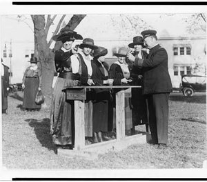 Women police officers inspecting and practicing with handguns.