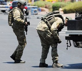 Las Vegas police officers prepare to go near the scene of a shooting in Las Vegas, Sunday.