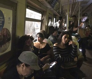 The New York Police Department says a minor derailment in Harlem caused a power outage that led to evacuations along the subway line.