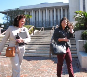 In a Tuesday, Jan. 30, 2018 photo, Leslie Dangerfield, left, and Jessica Realin, whose husband is now disabled after PTSD brought on by the Pulse nightclub massacre, leave the Florida Capitol after testifying for a bill that would extend workers compensation benefits to first responders who suffer from PTSD, in Tallahassee, Florida.