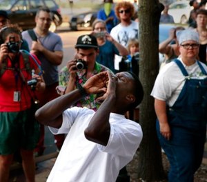 State Rep. Bruce Franks chants in front of the Buzz Westfall Justice Center as more than a hundred people wait for the release of almost two dozen people arrested earlier in the day at the Saint Louis Galleria mall, Saturday, Sept. 23, 2017, in Clayton, Mo.