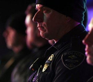 Brighton police officers wear a black ribbon over their badge for Adams County Sheriff's Deputy Heath Gumm in Brighton, Colo., Thursday, Jan. 25, 2018. (John Leyba/The Denver Post via AP)