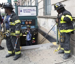 Emergency service personnel work at the scene of a subway derailment, Tuesday, June 27, 2017.