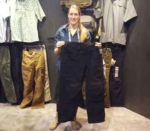 Lyndsey Grove — Marketing Campaign Manager for 5.11 Tactical — holds the XPRT Uniform pants, which feature 16 pockets, magnetic closures, and a patch of Kevlar sewn into the crotch.