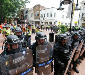 Virginia State Police cordon off an area around the site where a car ran into a group of protesters after a white nationalist rally in Charlottesville, Va., Saturday, Aug. 12, 2017.