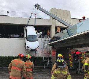 Firefighters Rescue Woman Dangling From Parking Garage