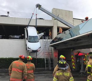 Miami-Dade Fire rescue crews jumped into action Thursday to rescue a driver from an SUV that was left dangling from a Miami Springs parking garage. (Photo/Miami Dade Rescue)