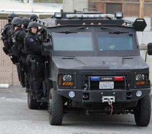 San Jose police officers with a Lenco BearCat tactical vehicle.