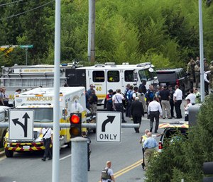 Authorities stage at the building entrance after multiple people were shot at The Capital Gazette newspaper in Annapolis, Md., Thursday, June 28, 2018.