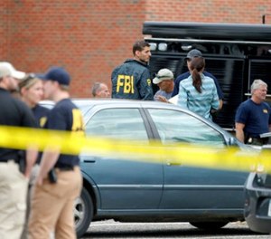 Law enforcement officials investigate an explosion at the Dar Al-Farooq Islamic Center in Bloomington, Minn., on Saturday, Aug. 5, 2017. (David Joles/Star Tribune via AP)