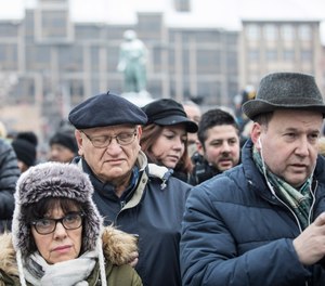 Residents react during a gathering in a central square of the eastern French city of Strasbourg, Sunday Dec.16, 2018 to pay homage to the victims of a gunman who killed five people and wounded a dozen more