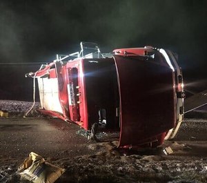 A Napoleon Volunteer Fire Department firefighter was injured in a rollover tanker crash on Tuesday. The firefighter said he was en route to a fire when his vision was obscured by the lights from another fire department's tanker.