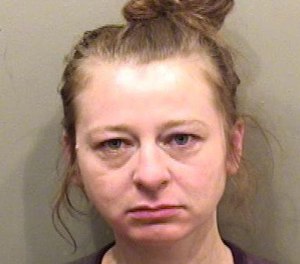 Laura Cooper, 35, is accused of spitting in a firefighter's face and throwing a kitchen plate at someone during an incident on Thursday.