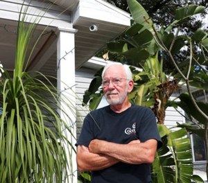 Patrick Holladay poses for a portrait in front of his Southeast Seminole Heights home on Monday, Dec. 18, 2017, in Tampa, Fla. (Alessandra Da Pra/Tampa Bay Times via AP)