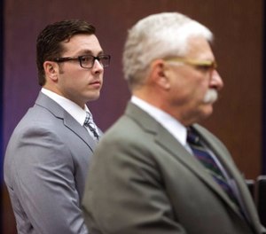 In this Oct. 25, 2017 file photo, Former Mesa police officer Philip Brailsford, left, and his attorney, Mike Piccarreta, stand for the jury, at the start of Brailsford's murder trial at Maricopa County Superior Court in Phoenix.