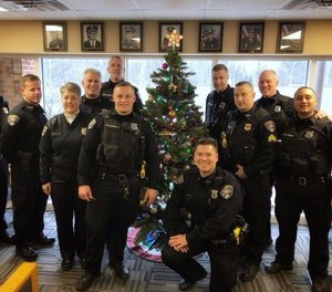 North Ridgeville police officers pose in front of Christmas decorations ahead of the holiday season in Ohio.