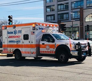 Police say a man who struck a Boston EMS ambulance and fled from the scene was located hiding on the rooftop of an industrial building.