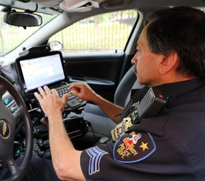 Sgt. Carello demonstrates how he uses his Zebra R12 Tablet to access critical data while in his cruiser.