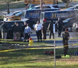 Arnold Police investigate the scene of a shooting of one of their own officers on Tuesday, Dec. 5, 2017, in the parking lot of the Arnold Police Station in Arnold, Mo.