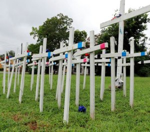 An impromptu memorial filled with crosses sits in a vacant lot seven blocks south of the state Capitol building in Little Rock, Ark., on Monday, Aug. 14, 2017.