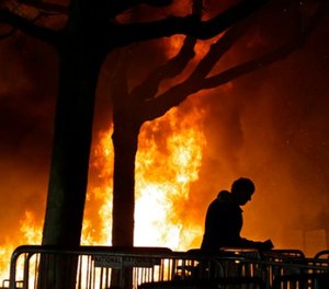 In this Wednesday, Feb. 1, 2017, file photo, a bonfire set by demonstrators protesting a scheduled speaking appearance by Breitbart News editor Milo Yiannopoulos in, burns on Sproul Plaza on the University of California at Berkeley campus on Berkeley, Calif.