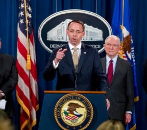 Deputy Attorney General Rod Rosenstein, center, accompanied by DEA Deputy Administrator Robert Patterson, left, Attorney General Jeff Sessions, second from right, and FBI Acting Director Andrew McCabe, right, speaks at a news conference to announce an international cybercrime enforcement action at the Department of Justice, Thursday, July 20, 2017, in Washington. (AP Photo/Andrew Harnik)