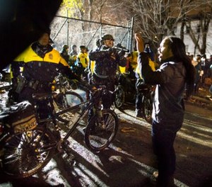 In this Nov. 18, 2015, file photo, Jeremiah Ellison, center right, son of U.S. Rep. Keith Ellison, stands near police during a protest at the Minneapolis Police Department 4th Precinct building in Minneapolis. (Renee Jones Schneider/Star Tribune via AP, File)