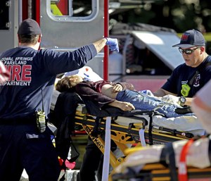 First responders tend to a victim after a mass shooting at Marjory Stoneman Douglas High School. (Photo/AP)