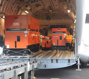 FEMA generators are being unloaded from a C-17 military cargo plane.