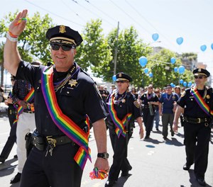 Then-San Francisco Chief of Police Greg Suhr waves while marching with officers in the 44th annual Gay Pride parade Sunday, June 29, 2014, in San Francisco.