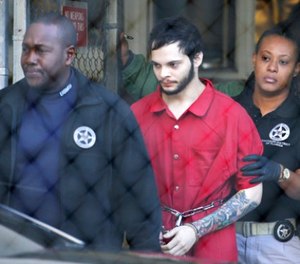 In this Jan. 30, 2017 file photo, Esteban Santiago, center, is led from the Broward County jail for an arraignment in federal court in Fort Lauderdale, Fla. (AP Photo/Lynne Sladky)
