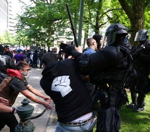 Police officers move to clear demonstrators from Chapman Square in downtown Portland, declaring it an unlawful assembly, near City Hall in downtown Portland, June. 4, 2017.